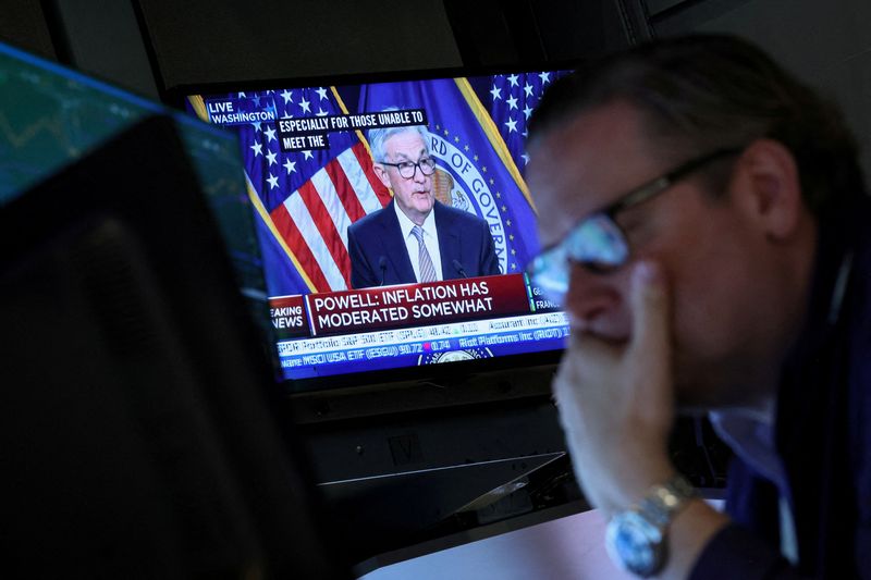 &copy; Reuters. FILE PHOTO: Traders react as Federal Reserve Chair Jerome Powell is seen delivering remarks on a screen, on the floor of the New York Stock Exchange (NYSE) in New York City, U.S., May 3, 2023.  REUTERS/Brendan McDermid/File Photo