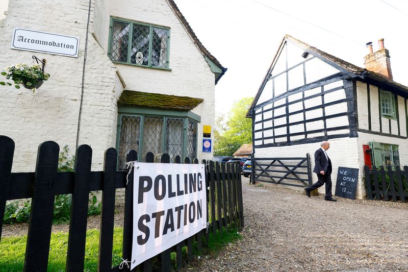 &copy; Reuters. A man walks near The Brocket Arms pub which is acting as a polling station for local elections in Ayot St Lawrence, Britain, May 4, 2023. REUTERS/Peter Cziborra