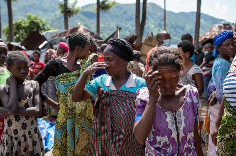 &copy; Reuters. Congolese women react after the death of their family members following rains that destroyed buildings and forced aid workers to gather mud-clad corpses into piles in the village of Nyamukubi, Kalehe territory in South Kivu province of the Democratic Repu