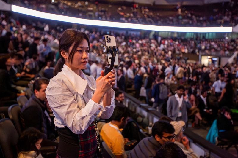 © Reuters. A person takes a picture as investors and guests arrive for the Berkshire Hathaway Inc annual shareholders' meeting in Omaha, Nebraska, U.S. May 6, 2023. REUTERS/Rachel Mummey