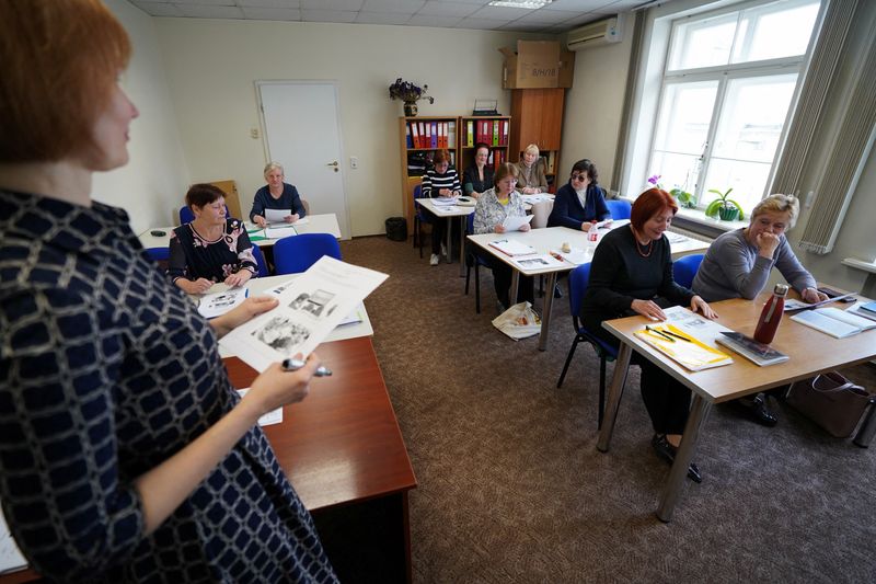 &copy; Reuters. FILE PHOTO: Teacher Inese Rudzite stands in front of Russian citizens during the Latvian language learning class in Riga, Latvia May 2, 2023. REUTERS/Janis Laizans