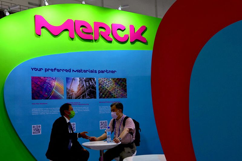 © Reuters. FILE PHOTO: People sit next to a Merck logo at SEMICON Taiwan in Taipei, Taiwan, September 14, 2022. REUTERS/Ann Wang