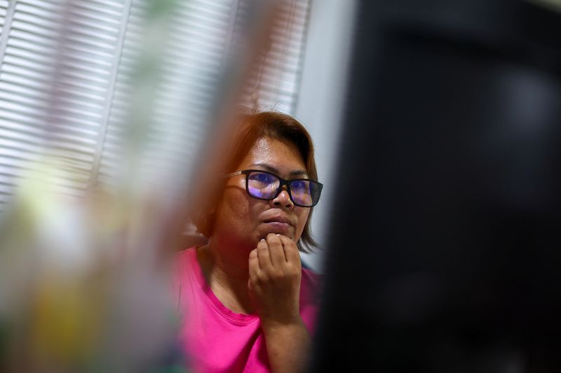 &copy; Reuters. Kavita Wongyakasem, a small business owner, reacts as she finds out that her bank account is insufficient to pay her bills at her house in Nonthaburi province on the outskirt of Bangkok, Thailand, April 28, 2023. REUTERS/Athit Perawongmetha