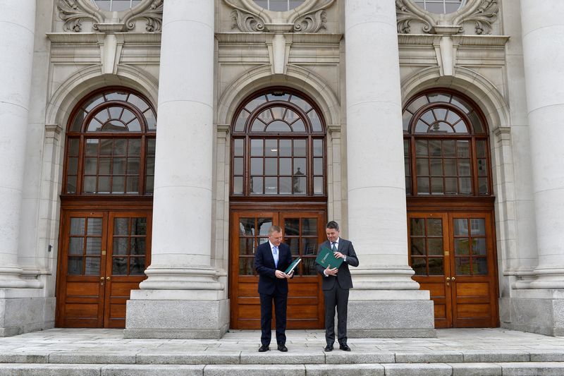 &copy; Reuters. FILE PHOTO: Ireland's Minister for Finance Paschal Donohoe and Minister for Public Expenditure and Reform Michael McGrath hold the Budget 2022 documents in the courtyard of Government Buildings, Dublin, Ireland, October 12, 2021. REUTERS/Clodagh Kilcoyne