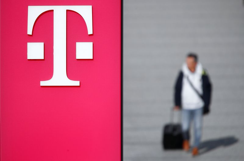 &copy; Reuters. FILE PHOTO: A man walks past the logo of Deutsche Telekom AG at the headquarters of German telecommunications giant in Bonn, Germany, February 19, 2019.   REUTERS/Wolfgang Rattay