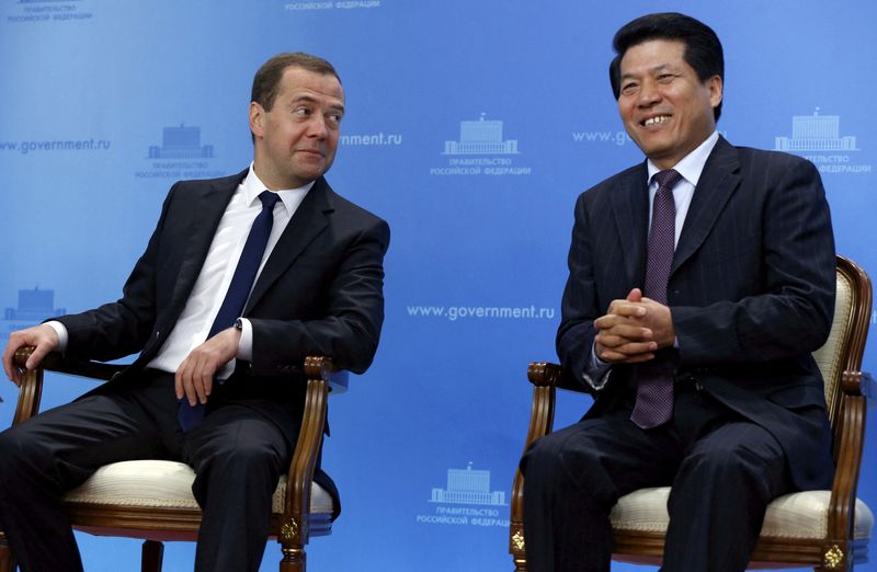 &copy; Reuters. FILE PHOTO: Li Hui, China's special representative for Eurasian affairs, (R)  sat with Russian Prime Minister Dmitry Medvedev (L)  during his time as ambassador to Moscow. They were attending a video conference, to  mark the start of the construction of t