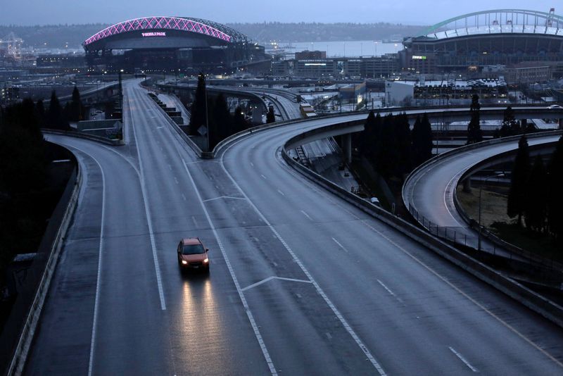 &copy; Reuters. FILE PHOTO: A car moves along an empty highway during the coronavirus disease (COVID-19) outbreak in Seattle, Washington, U.S. March 30, 2020.  REUTERS/David Ryder/File Photo