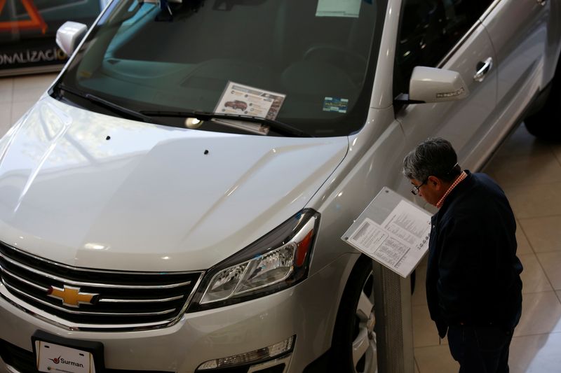 &copy; Reuters. FILE PHOTO: A customer checks out details of a Chevrolet Traverse being displayed at Surman Chevrolet car dealership in Mexico City, Mexico January 9, 2018. REUTERS/Ginnette Riquelme