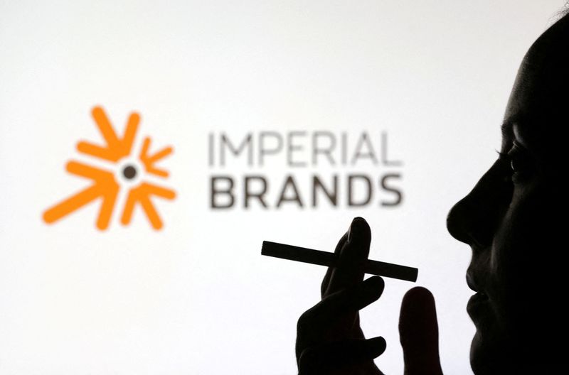 &copy; Reuters. FILE PHOTO: A woman poses with a cigarette in front of Imperial Brands logo in this illustration taken July 26, 2022. REUTERS/Dado Ruvic/Illustration