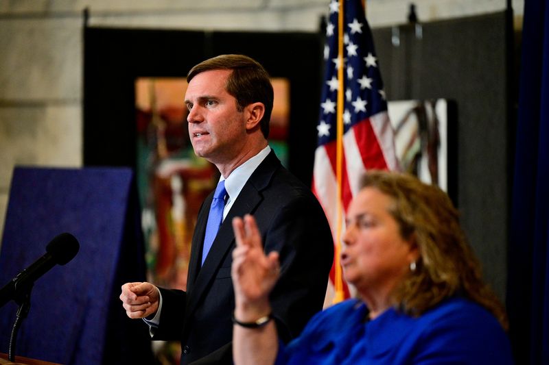 &copy; Reuters. Kentucky's Democratic Governor Andy Beshear speaks during a memorial service for those who died from the coronavirus disease (COVID-19), held on the Capitol grounds in Frankfort, Kentucky, U.S., November 14, 2021. REUTERS/Jon Cherry/File Photo