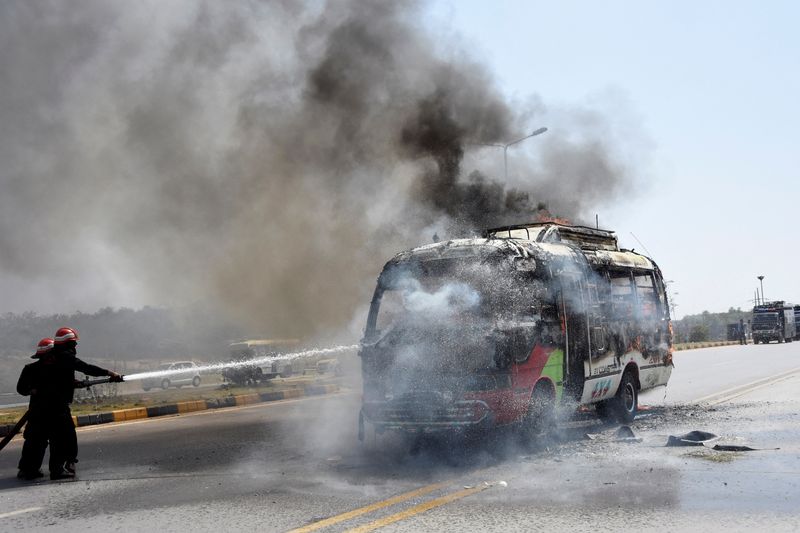&copy; Reuters. Firefighters try to douse a bus that caught fire during clashes with the supporters of Pakistan's former Prime Minister Imran Khan in Islamabad, Pakistan, May 12, 2023. REUTERS/Stringer