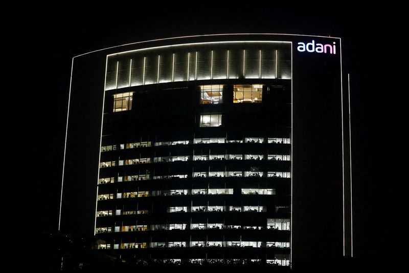 &copy; Reuters. FILE PHOTO: The logo of the Adani Group is seen on the facade of its Corporate House on the outskirts of Ahmedabad, India, January 27, 2023. REUTERS/Amit Dave