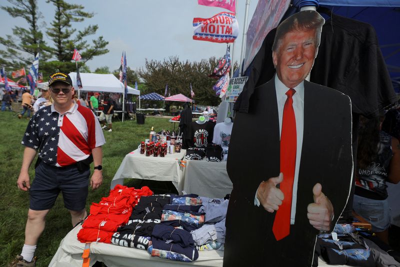 &copy; Reuters. A cardboard cutout of former U.S. President and Republican presidential candidate Donald Trump stands next to merchandise for sale, after his campaign rally was postponed due to severe weather, in Des Moines, Iowa, U.S., May 13, 2023. REUTERS/Brian Snyder