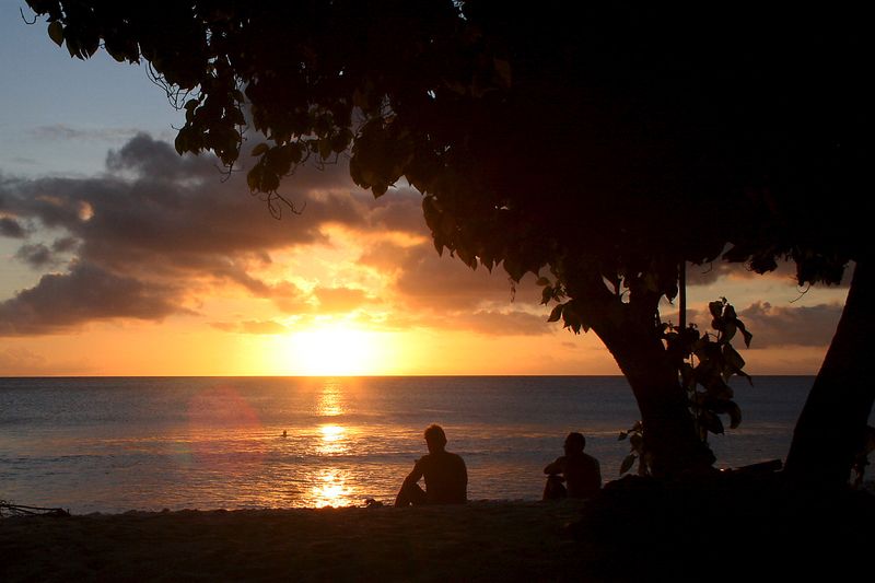 © Reuters. FILE PHOTO: Surfers watch the sun set after surfing along the coast of Kiritimati Island, part of the Pacific Island nation of Kiribati, April 5, 2016. To match Feature PACIFIC-JUSTICE/ REUTERS/Lincoln Feast