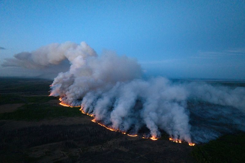 &copy; Reuters. FILE PHOTO: Smoke rises from the Stoddart Creek wildfire near Fort St. John, British Columbia, Canada May 13, 2023.  B.C. Wildfire Service/Handout via REUTERS 