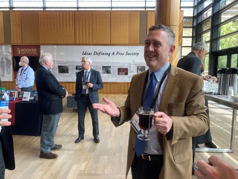 &copy; Reuters. FILE PHOTO: Federal Reserve Bank of St. Louis President James Bullard chats, during a break at a conference on monetary policy at Stanford University's Hoover Institution, in Palo Alto, California, U.S. May 6, 2022. Picture taken May 6, 2022. REUTERS/Ann 