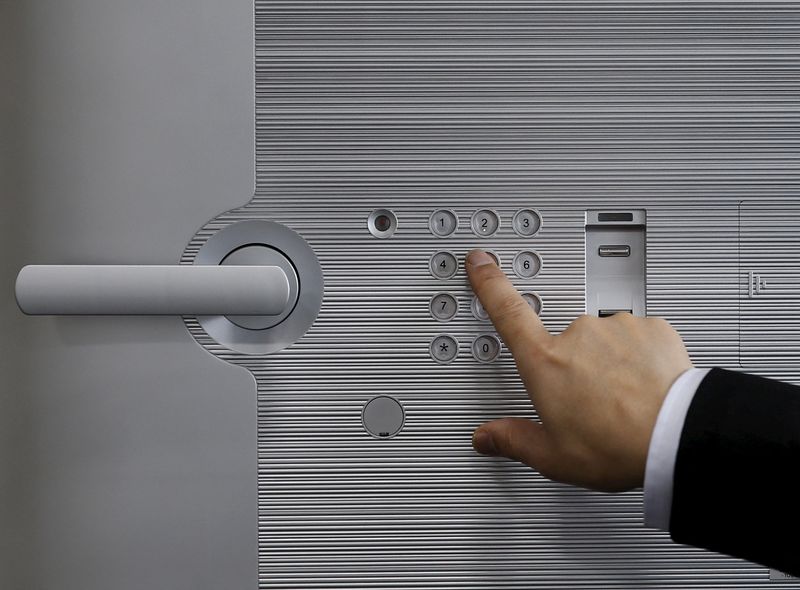 &copy; Reuters. FILE PHOTO: A staff enters a pass code for a safety deposit box during a photo opportunity at a security showroom in Tokyo, Japan, March 23, 2016. REUTERS/Yuya Shino