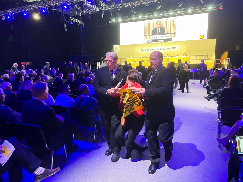Shell CEO shielded by security as climate protesters storm AGM
