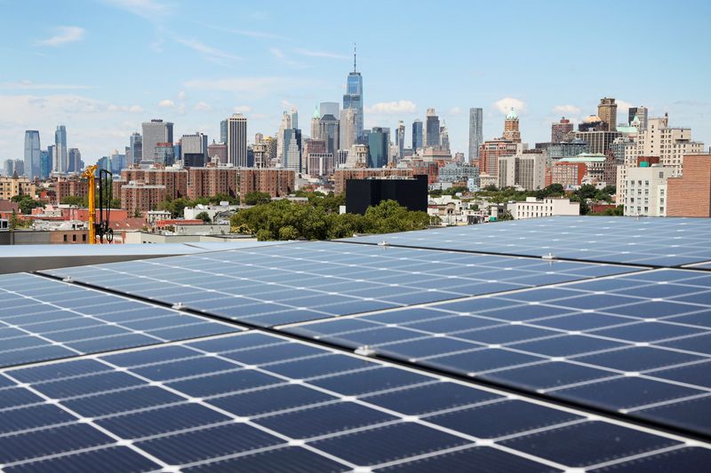 &copy; Reuters. FILE PHOTO: Solar panels are seen along with a view of the neighborhood and lower Manhattan from the rooftop of Timber House, the city's first mass-timber condo building, in the Park Slope neighborhood of Brooklyn, New York, U.S., August 16, 2022.  REUTER