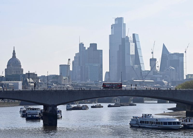 © Reuters. FILE PHOTO: Boats are anchored in the River Thames, with buildings in the City of London financial district seen behind, as the British government announced it was accelerating plans to protect London from flooding caused by a warming climate and rising sea levels, in London, Britain, May 17, 2023. REUTERS/Toby Melville/File Photo