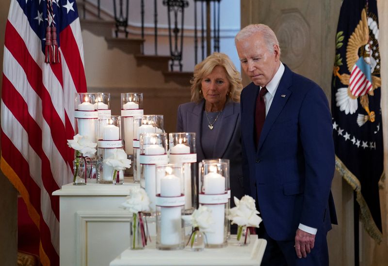 &copy; Reuters. U.S. President Joe Biden and first lady Jill Biden pause to look at a diisplay of candles as they mark the first anniversary of the school shooting at Robb Elementary School in Uvalde, Texas, during an event at the White House in Washington, U.S., May 24,