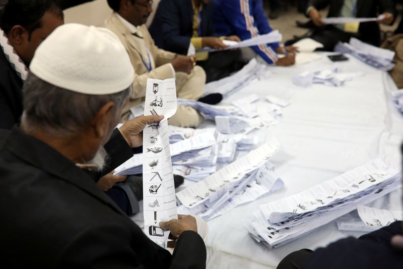 &copy; Reuters. FILE PHOTO: A presiding officer counts votes at a voting center after the session has ended in Dhaka, Bangladesh, December 30, 2018. REUTERS/Mohammad Ponir Hossain