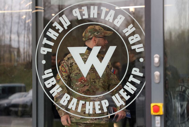 &copy; Reuters. FILE PHOTO: A man wearing a camouflage uniform walks out of PMC Wagner Centre, which is a project implemented by the businessman and founder of the Wagner private military group Yevgeny Prigozhin, during the official opening of the office block in Saint P