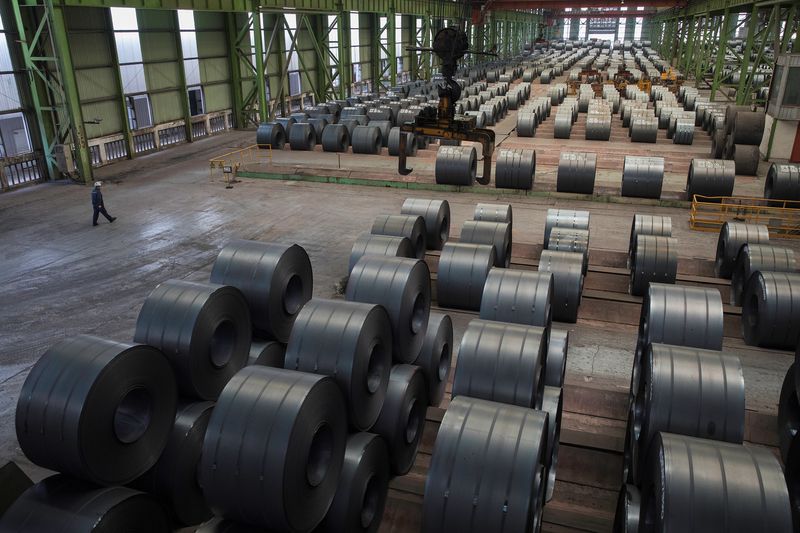 &copy; Reuters. A worker walks by steel rolls at the Chongqing Iron and Steel plant in Changshou, Chongqing, China August 6, 2018. Picture taken August 6, 2018. REUTERS/Damir Sagolj/File Photo