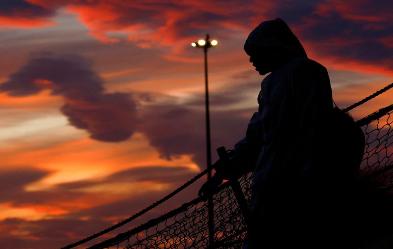 © Reuters. FILE PHOTO: A person disembarks the Geo Barents rescue ship, operated by Medecins Sans Frontieres (Doctors Without Borders), in Bari, Italy March 26, 2023. REUTERS/Darrin Zammit Lupi/File Photo