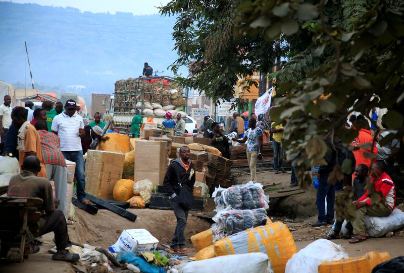 &copy; Reuters. FILE PHOTO: Ugandan business people are seen at a market with their merchandises for sale at Mpondwe border that separates Uganda and the Democratic Republic of Congo, in Mpondwe, Uganda, June 14, 2019. REUTERS/James Akena/File Photo