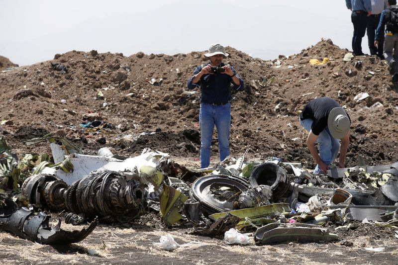 &copy; Reuters. FILE PHOTO: American civil aviation and Boeing investigators search through the debris at the scene of the Ethiopian Airlines Flight ET 302 plane crash, near the town of Bishoftu, southeast of Addis Ababa, Ethiopia March 12, 2019. REUTERS/Baz Ratner