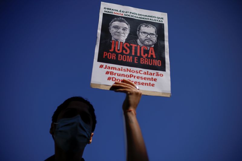 &copy; Reuters. A demonstrator holds a sign during a protest, to demand justice for journalist Dom Phillips and indigenous expert Bruno Pereira, who were murdered in the Amazon, in Brasilia, Brazil June 19, 2022. REUTERS/Ueslei Marcelino