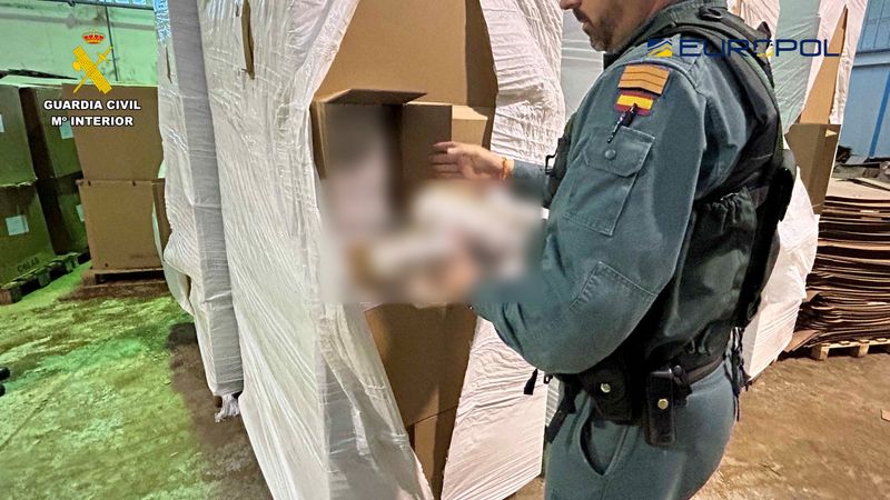 &copy; Reuters. A Spanish Civil Guard officer handles material from boxes containing illegal tobacco during a raid where more than 3.5 million packets of contraband tobacco were seized, in Seville, Spain, in this picture released on January 22, 2023. Guardia Civil/Handou