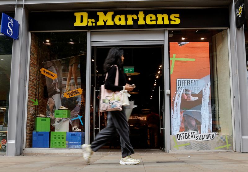 &copy; Reuters. FILE PHOTO-A woman walks past a Dr. Martens store in Manchester, Britain, May 26, 2023. REUTERS/Jason Cairnduff