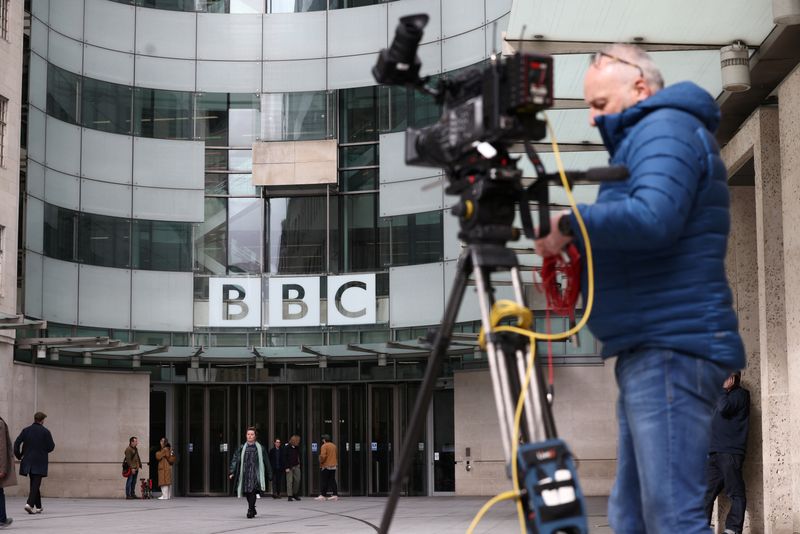 &copy; Reuters. FILE PHOTO: A man stands by a camera outside the British Broadcasting Corporation (BBC) headquarters in London, Britain, March 13, 2023. REUTERS/Henry Nicholls