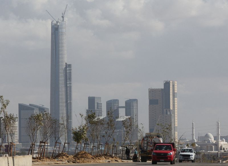 &copy; Reuters. FILE PHOTO: Vehicles drive on a road next to the construction site of the Iconic Tower skyscraper in the Central Business District (CBD), which is being built by China State Construction Engineering Corp (CSCEC) in the New Administrative Capital (NAC) eas