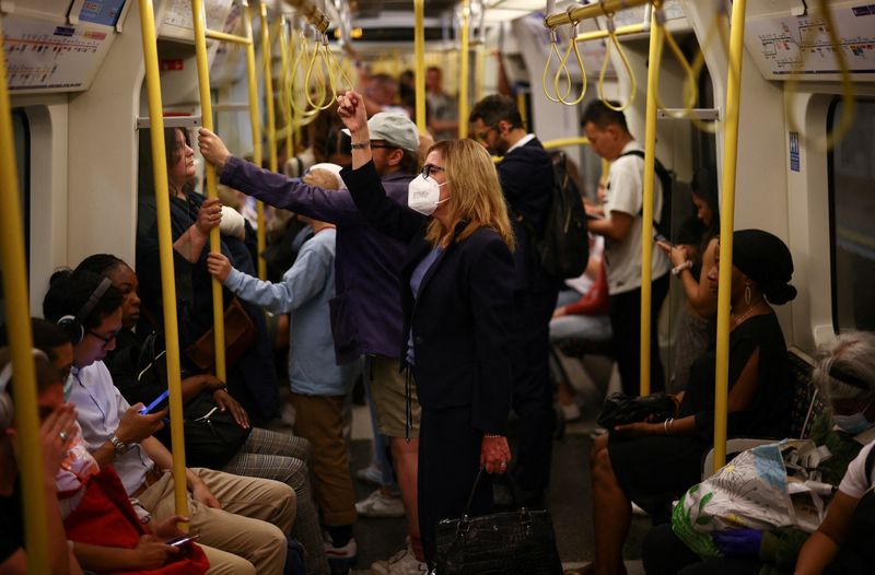 &copy; Reuters. FILE PHOTO: A person wearing a protective face mask travels on a London Underground train in London, Britain, July 25, 2022. REUTERS/Henry Nicholls