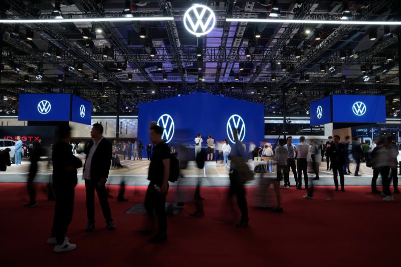 &copy; Reuters. FILE PHOTO: Visitors walk past the Volkswagen booth at the Auto Shanghai show, in Shanghai, China April 18, 2023. REUTERS/Aly Song