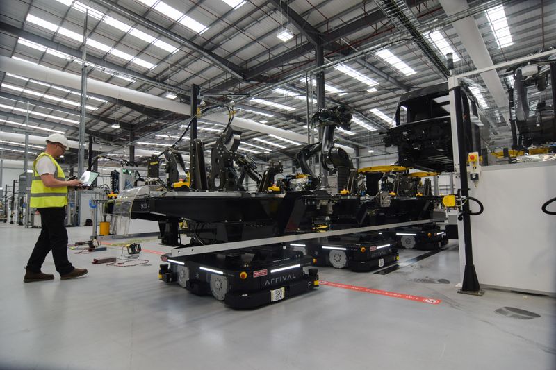 &copy; Reuters. An engineer at electric van maker Arrival watches as autonomous robots move parts for a prototype vehicle at the company's factory in Bicester, Britain, May 10, 2023. REUTERS/Nick Carey