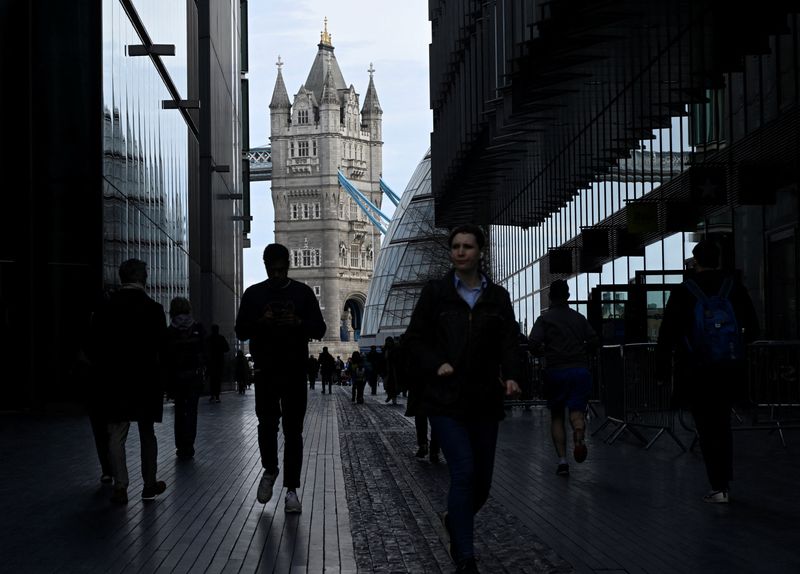 &copy; Reuters. FILE PHOTO: People walk through the 'More London' business district with Tower Bridge seen behind in London, Britain, March 16, 2023. REUTERS/Toby Melville