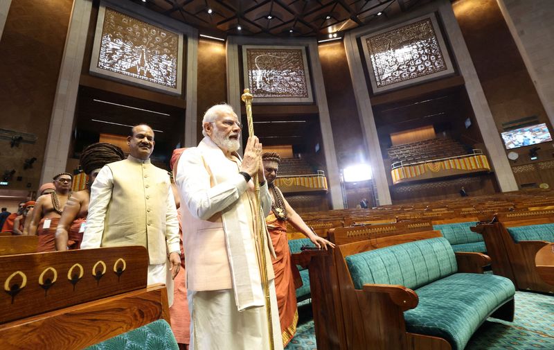 &copy; Reuters. FILE PHOTO: India's Prime Minister Narendra Modi carries a sengol as Speaker of the Lok Sabha Om Birla looks on during the inauguration of new Parliament building in New Delhi, India, May 28, 2023. India's Press Information Bureau/Handout via REUTERS