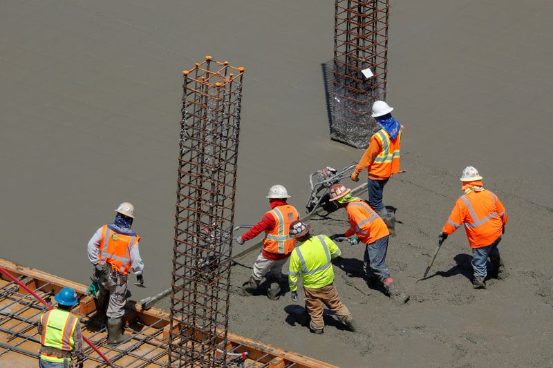 &copy; Reuters. FILE PHOTO: Workers pour cement at a construction site for an office town in downtown San Diego, California, U.S., April 23, 2019. REUTERS/Mike Blake/File Photo