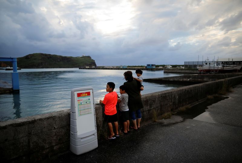 &copy; Reuters. Local children look on at Japan's westernmost inhabited Yonaguni Island in Yonaguni, Okinawa prefecture, Japan, October 26, 2021. Picture taken October 26, 2021.  REUTERS/Issei Kato/File Photo