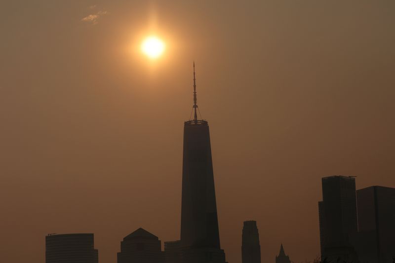 &copy; Reuters. The One World Trade Center tower in lower Manhattan in New York City is pictured shortly after sunrise as haze and smoke caused by wildfires in Canada hang over the Manhattan skyline in as seen from Jersey City, New Jersey, U.S., June 8, 2023. REUTERS/Mik