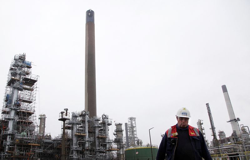 &copy; Reuters. FILE PHOTO: A worker walks at the Coryton oil refinery in south-eastern England January 24, 2012. REUTERS/Stefan Wermuth