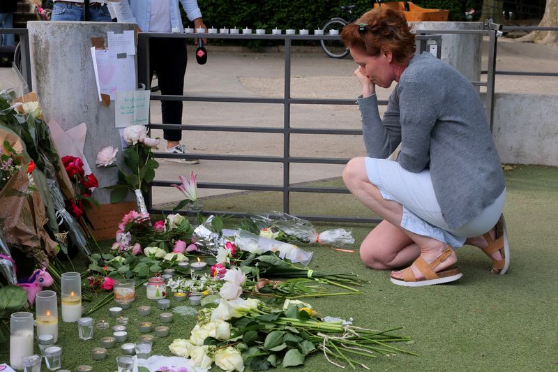 &copy; Reuters. A woman pays respect in front of messages and floral tributes at the children's playground the day after several children and adults were injured in a knife attack at the Le Paquier park near the lake in Annecy, in the French Alps, France, June 9, 2023. R