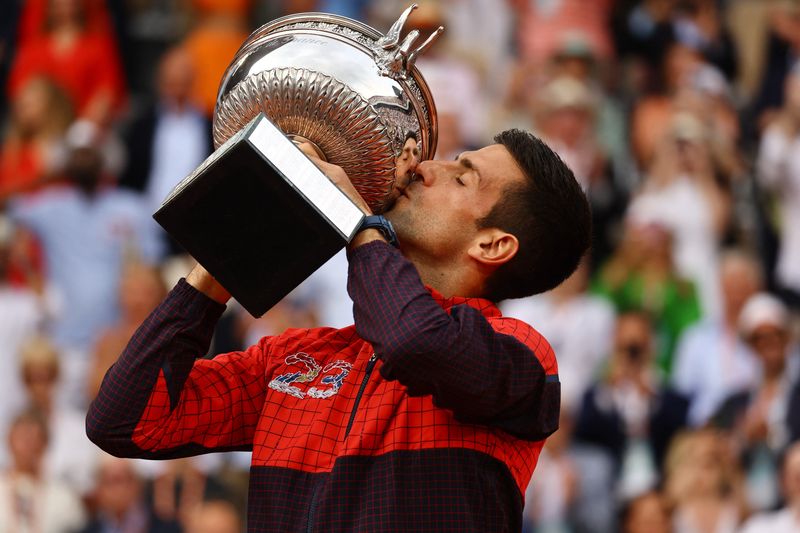 © Reuters. Tennis - French Open - Roland Garros, Paris, France - June 11, 2023 Serbia's Novak Djokovic kisses the trophy after winning the French Open REUTERS/Kai Pfaffenbach