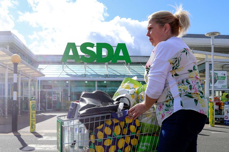 &copy; Reuters. FILE PHOTO: A woman pushes a shopping cart at an Asda superstore at the Gateshead Metrocentre,  in Gateshead, Britain, March 26, 2021. REUTERS/Lee Smith/File Photo