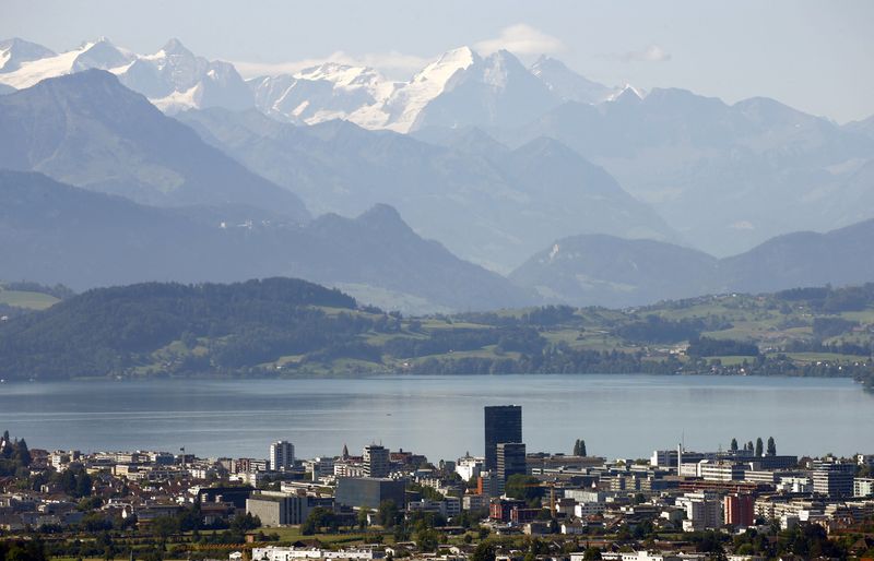 &copy; Reuters. FILE PHOTO: The snow-covered peaks of Bernese Oberland are seen behind Lake Zug and the city of Zug, Switzerland August 20, 2020.  REUTERS/Arnd Wiegmann/File Photo