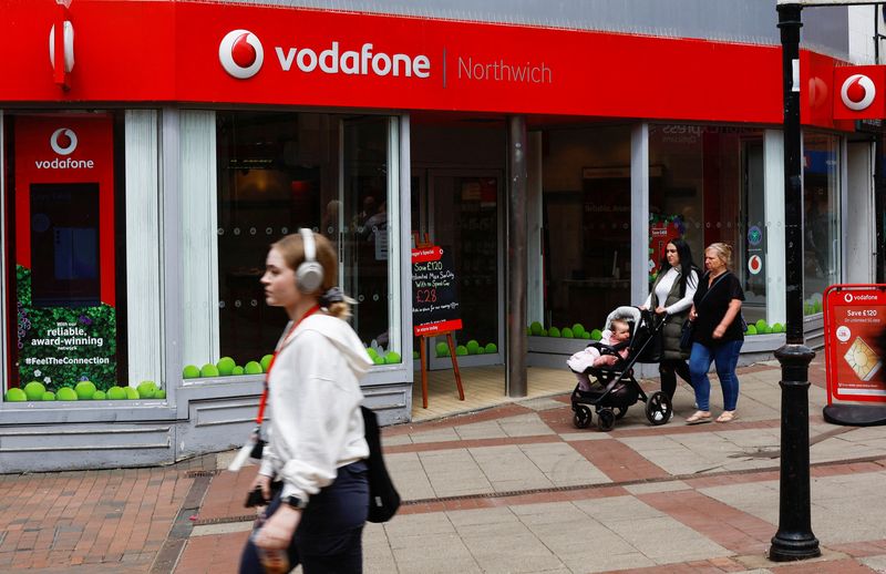&copy; Reuters. FILE PHOTO: People walk past a Vodafone store in Northwich, Cheshire, Britain, June 7, 2023. REUTERS/Jason Cairnduff/File Photo
